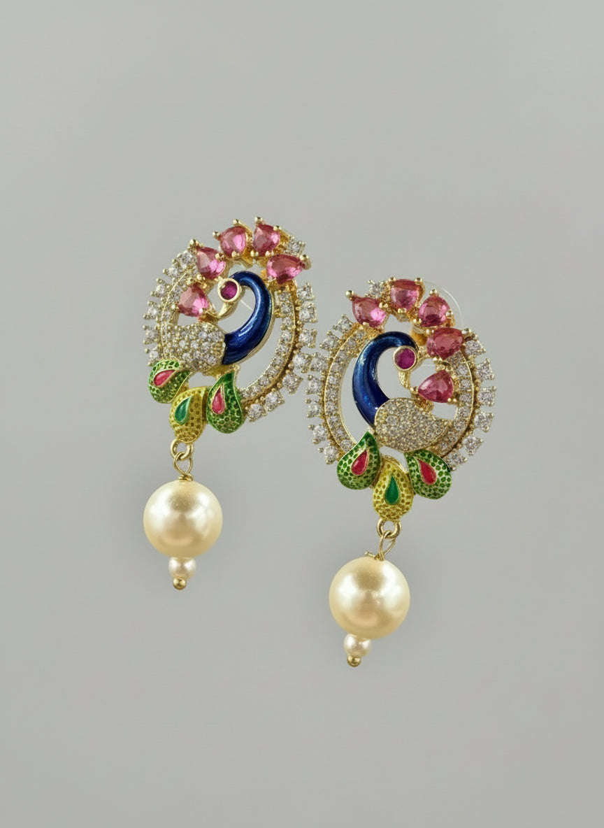 A rhodium-gold plated peacock design accompanied earrings, featuring vibrant green, blue, enamel accents, as well as sparkling crystal white and ruby pink stones. Earrings design is focused.