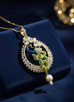A rhodium-gold plated peacock design pendant with silver chain ,featuring vibrant green, blue, enamel accents, as well as sparkling crystal white AD stones. Pendant with silver chain design is focused.