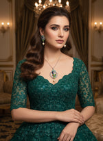 A rhodium-silver plated brass pendant with a peacock design accompanied by earrings, featuring vibrant green, blue, and gold enamel accents, as well as sparkling white and turquoise ad crystal embellishments.