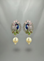 A rhodium-silver plated peacock design accompanied earrings, featuring vibrant green, blue and yellow enamel accents, as well as sparkling white andpink crystal stones. Earrings design is focused.