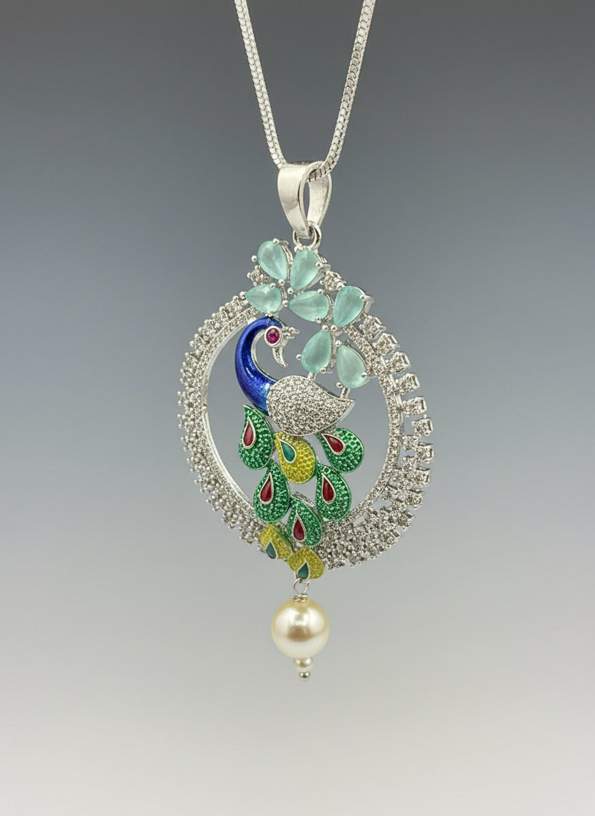 A rhodium-silver plated peacock design pendant with silver chain ,featuring vibrant green, blue, enamel accents, as well as sparkling crystal white and turquoise stones. Pendant with silver chain design is focused.