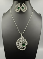 A set of artificial AD pendants with bottle green centre stone in the pendant and in earrings, featuring a geometric design with intricate detailing, displayed on a mannequin. Party wear set.