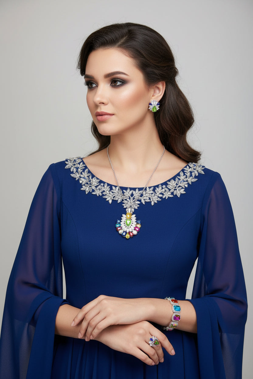 A set of jewellery featuring a multi-coloured gemstone pendant necklace, matching earrings, and a bracelet, displayed on a black mannequin bust.