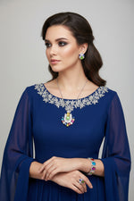 A set of jewellery featuring a multi-coloured gemstone pendant necklace, matching earrings, and a bracelet, displayed on a black mannequin bust.