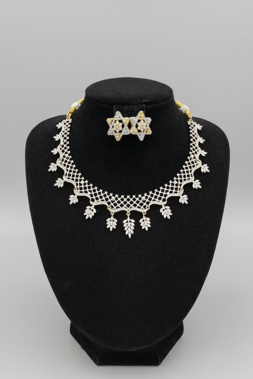 A silver and gold jewellery set displayed on a black velvet mannequin bust, featuring a lace-like collar necklace with leaf-shaped charms and a matching Star shape studs.