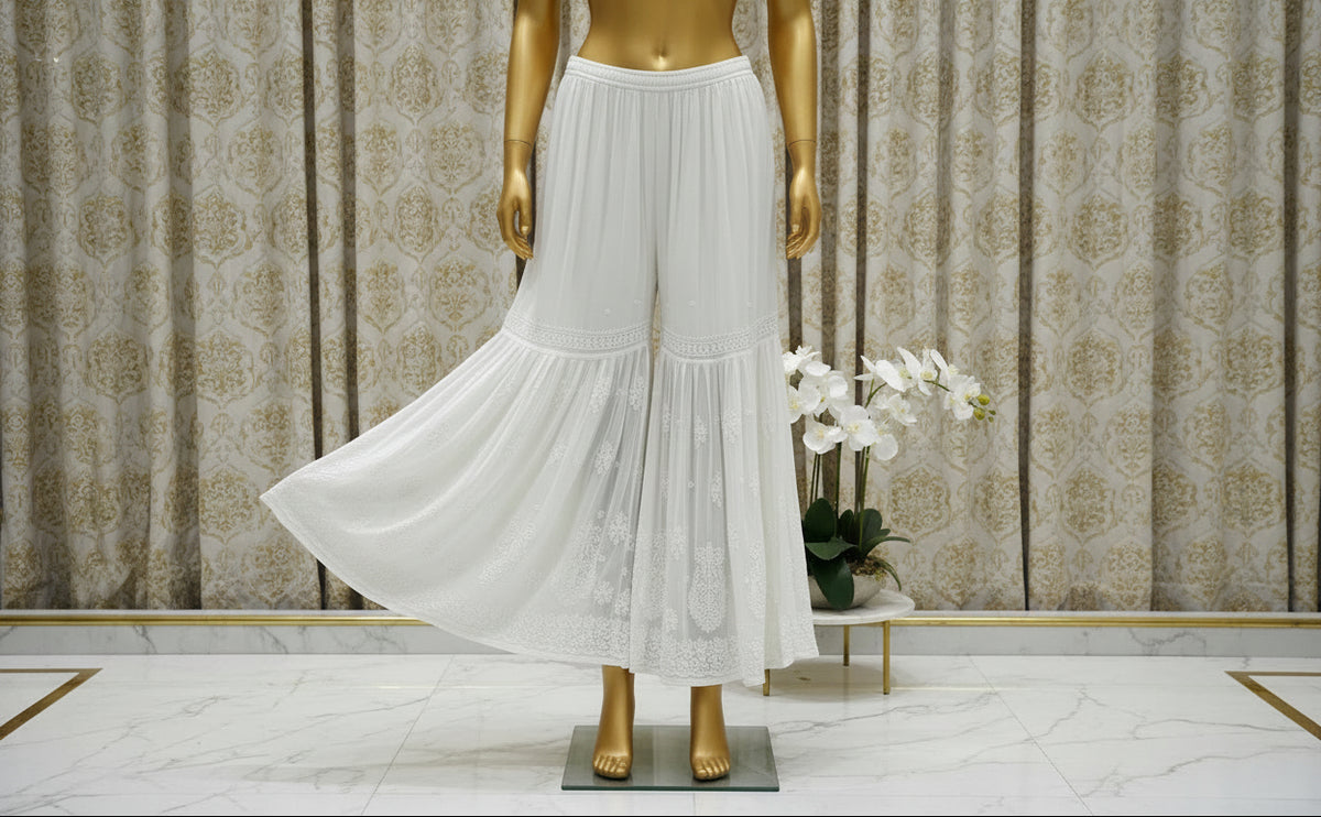 A white flared hand embroidered gharara trousers