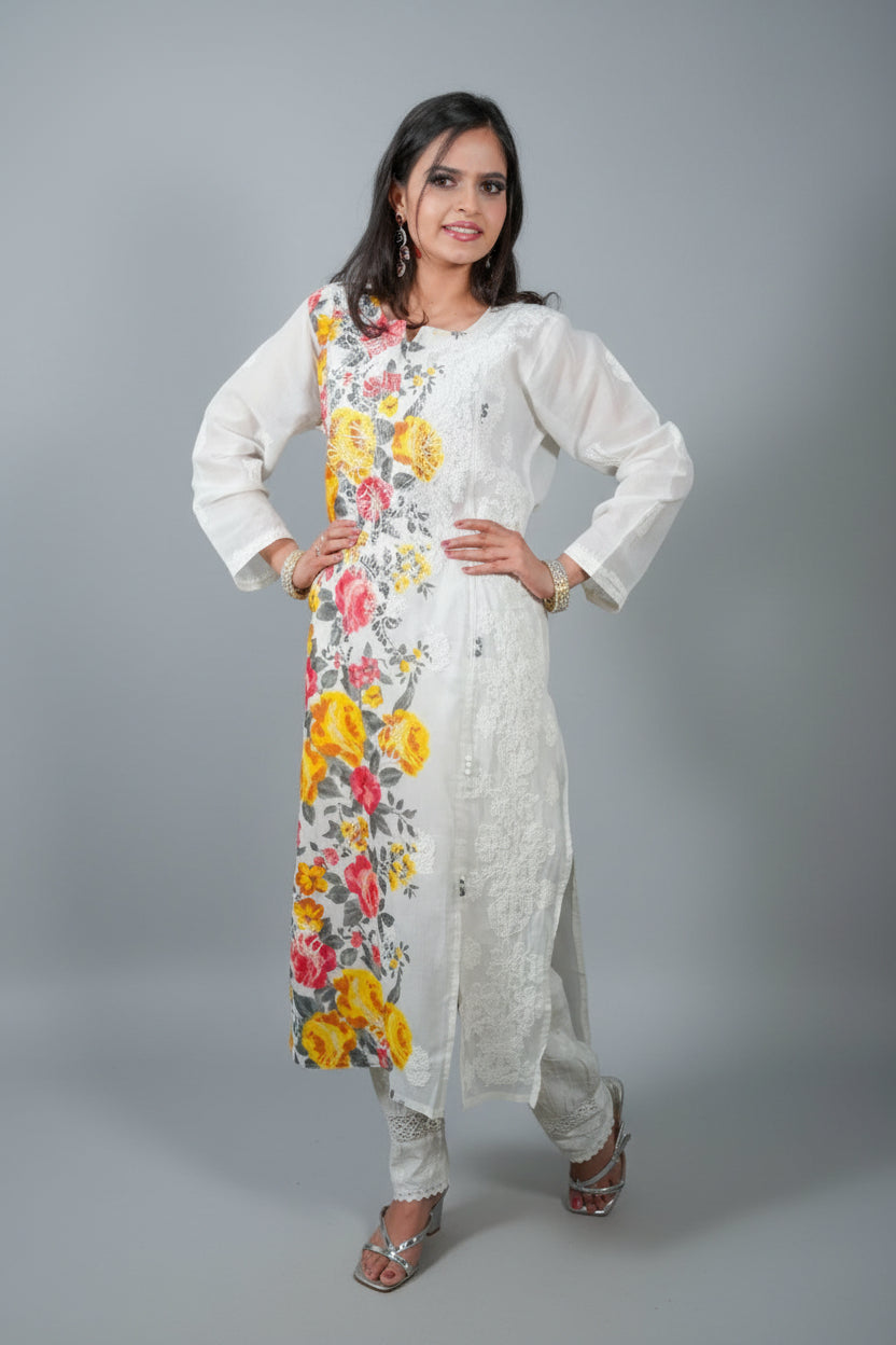 A woman modeling a long white cotton kurti with hand-painted floral Chikankari designs in blue, green, yellow, and pink.