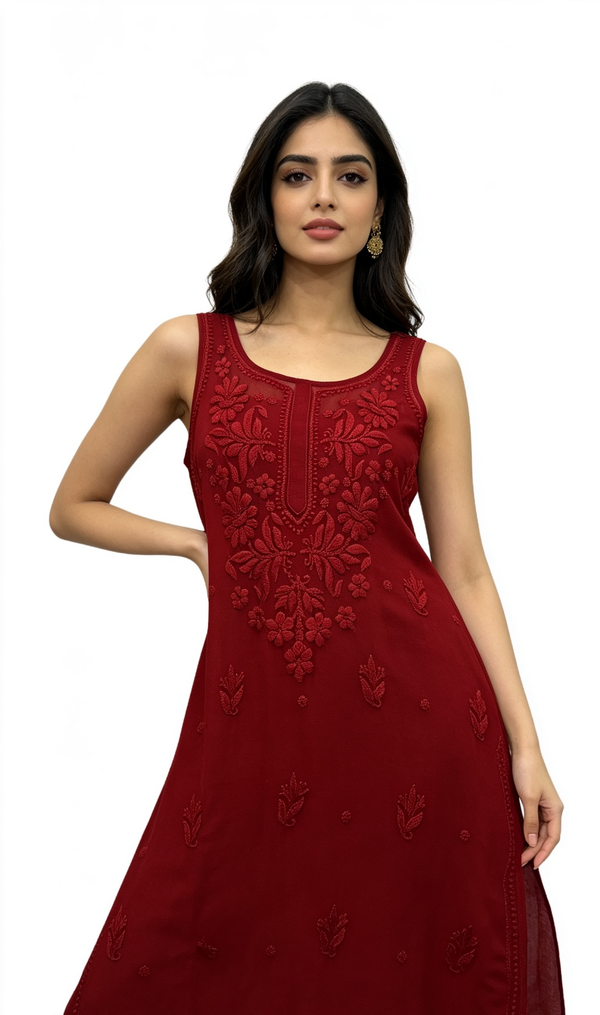 A woman modelling a sleeveless red anarkali dress with intricate floral embroidery on the bodice and scattered embroidery on the skirt, set against a plain white background.