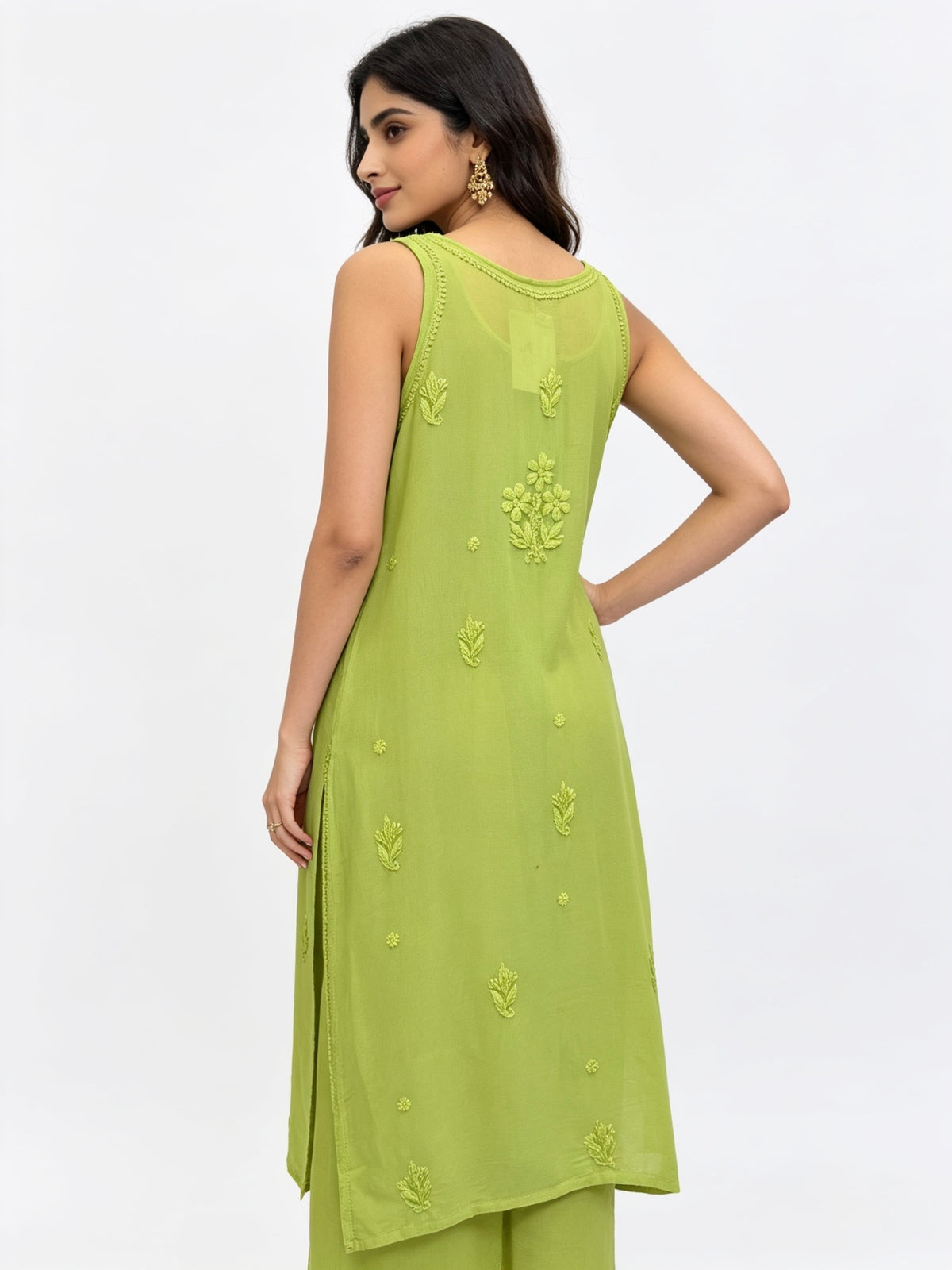 A woman modelling the rear view of this sleeveless lime green kurta with matching green pants, shown from a side-back angle against a plain white studio background.
