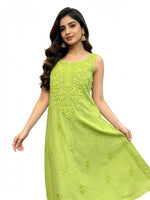 A woman modelling the rear view of this sleeveless lime green kurta with matching green pants, shown from a side-back angle against a plain white studio background and showing the bottom of the kurti.
