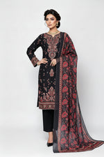 A woman models a traditional South Asian salwar kameez set featuring a black kurta with intricate red and gold floral embroidery, black trousers, and a matching sheer dupatta with a red and black floral pattern.