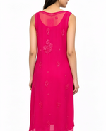 A woman wearing a sleeveless hot pink kurta with tonal floral embroidery, shown from the back against a plain white background.