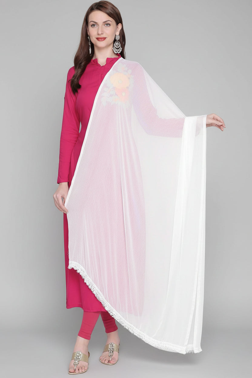 A woman wearing a white chiffon dupatta with lace on both sides, draped over the shoulders.