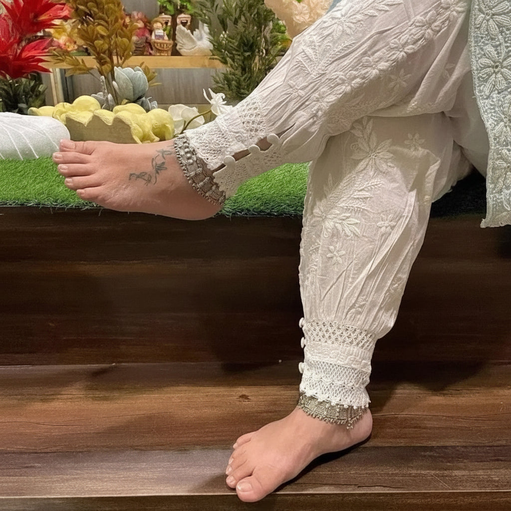 model with crossed legs wearing Chikankari Afghani pants