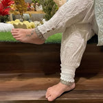 model with crossed legs wearing Chikankari Afghani pants