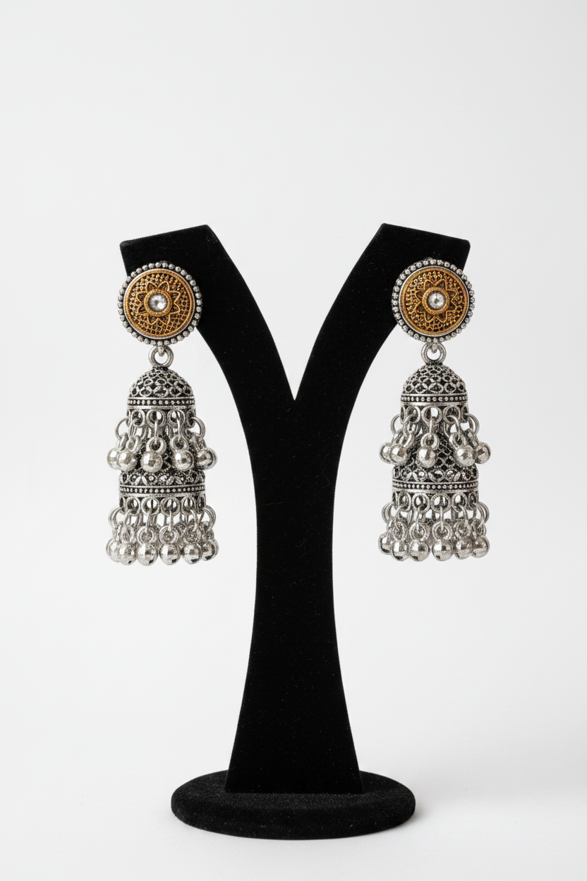 Close-up of stone studding and dual-tone gold and silver filigree detailing on jhumka