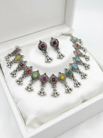 Antique finish oxidised silver coated alloy metal jewellery set displayed on a grey linen product stand.