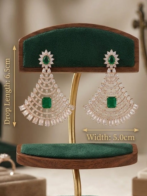 A pair of large drop earrings displayed on a wooden and velvet jewelry stand, with overlaid dimension labels showing drop length 6.5 cm, width 5.