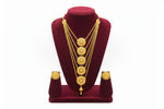 A studio shot of the Ayesha Elite gold-plated multi-layered necklace and matching stud earrings displayed on a black velvet jewelry stand against a white background by Famaza Couture.