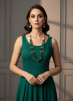 Beaded mala with silver and pearl beads in on both sides start and drop is designed with dark green nano glass bead with silver ball beads, along withLotus design earrings with silver and pearl beads in drop. Oxidised jewellery set.