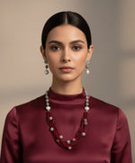 Beaded mala with silver and pearl beads in on both sides start and drop is designed with maroon colour nano glass bead with silver ball beads, along withLotus design earrings with silver and pearl beads in drop. Oxidised party wear jewellery set.