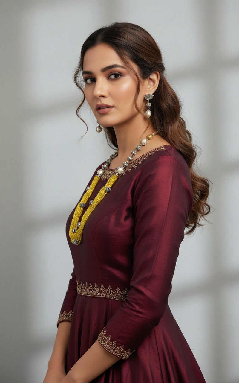 Beaded mala with silver and pearl beads in on both sides start and drop is designed with yellow nano glass bead with silver ball beads, along withLotus design earrings with silver and pearl beads in drop. Oxidised party wear jewellery set.