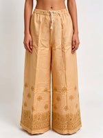 Beige pants with floral embroidery on a white background