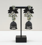 Black Colour pair of jhumki earrings with leaf patterns and silver coloured stones, featuring gold-plated brass metal and nano hangings.