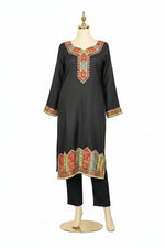 A black silk kurta set featuring Kanni embroidery and zari work, paired with a Banarasi chiffon dupatta and raw silk trousers, displayed on a high-end stand against a pure white background.