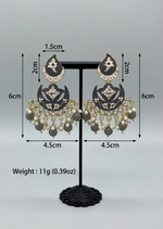Black and gold earrings with pearl-like beads on a stand, showing measurements and weight.