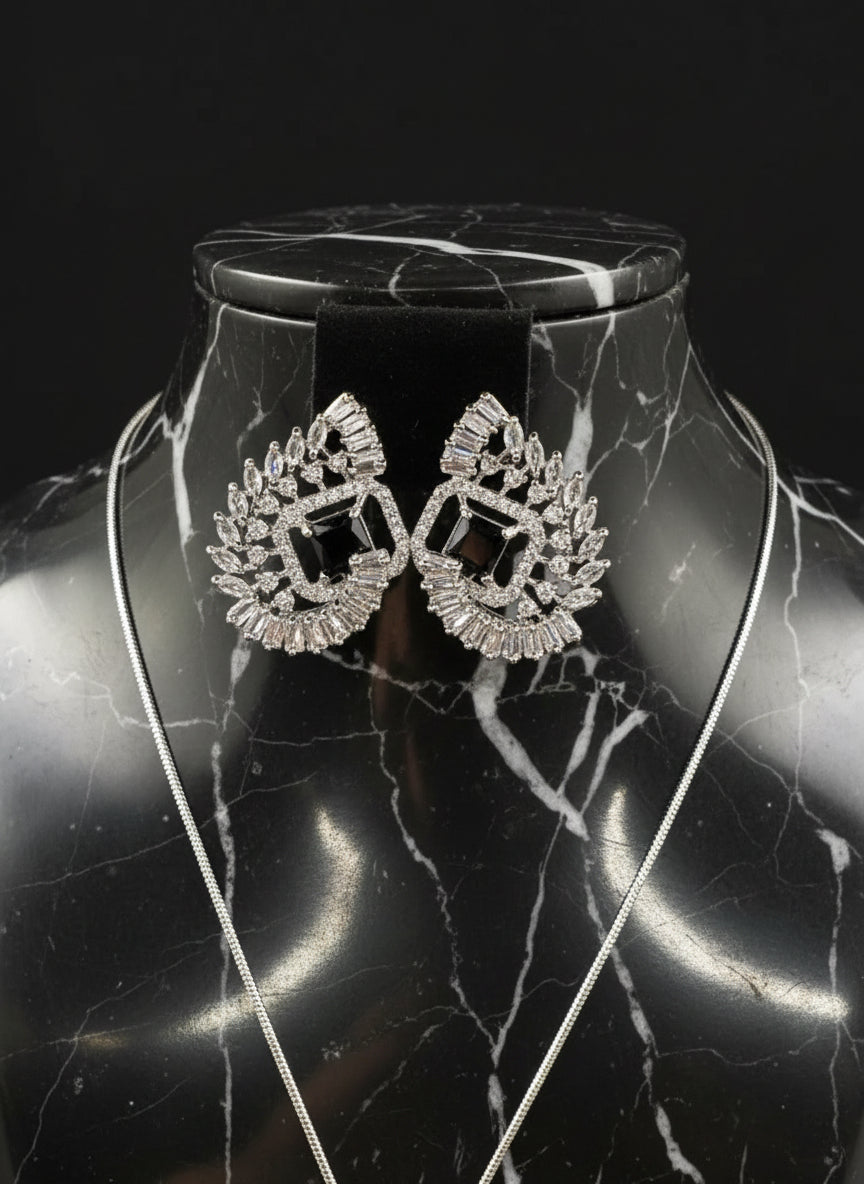 Black centre stone earrings, featuring a geometric design with intricate detailing, displayed on a mannequin. Party wear set.