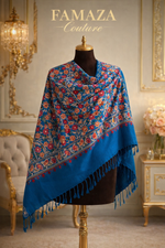 Blue floral-patterned shawl on a mannequin in an elegant room with 'Famaza Couture' branding.
