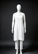 Full-length front view of the white handcrafted sleeveless Chanderi silk Chikankari co-ord set displayed on a white mannequin against a dark contrasting background.