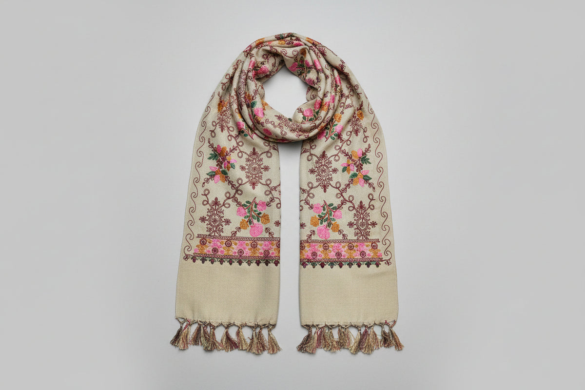 Close-up of a Kashmiri embroidered pashmina scarf featuring floral patterns with detailed embroidery and tassels.