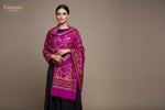 Close-up of a magenta Kashmiri embroidered pashmina scarf with floral patterns and golden embellishments.