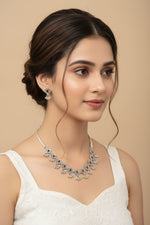 Close-up of a woman wearing a delicate oxidised choker featuring carved floral petals and black gemstone centers.