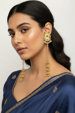 Close-up of model showcasing dramatic 22cm bottle green gold bell earrings, perfect for party wear and bridal jewellery.