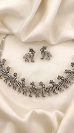 Close-up of the elite deer trail necklace showcasing the intricate silver-coated motifs and antique finish.