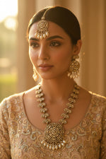 Close-up of the rose gold stone and nano pearl intricate metalwork on the bridal necklace.