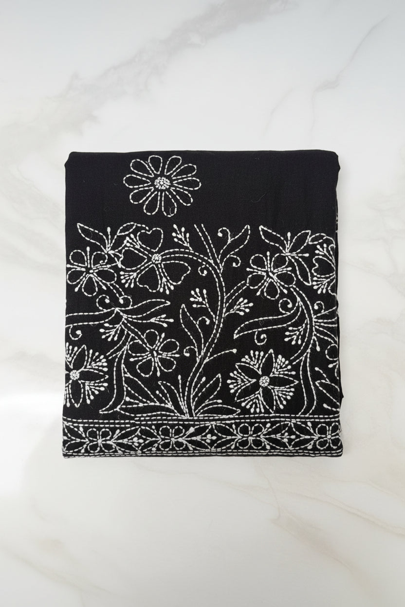 Close up white Chikankari paisley hand embroidery on black cotton flared pants