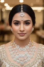 Detailed close-up of floral Kundan motifs and white pearl layering on a traditional Indian bridal necklace set.