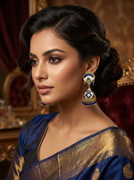 Detailed shot of the blue and white enamel patterns and small hanging blue beads on the Meenakari jhumka.