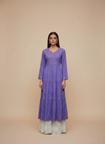 Purple dobby cotton long dress with a white flared trousers on a mannequin in a store setting