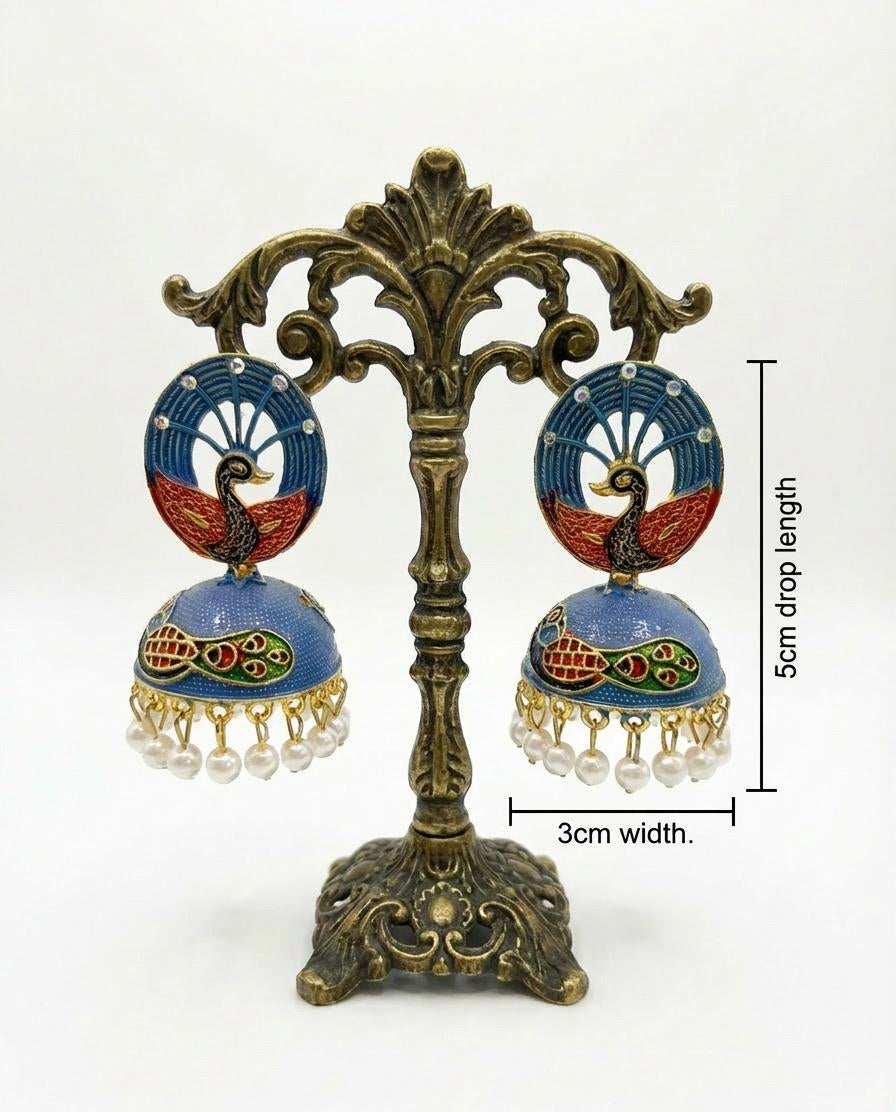 Dual-tone blue and red 5.5cm peacock jhumkas on a stand featuring vibrant hand-painted bird motifs.