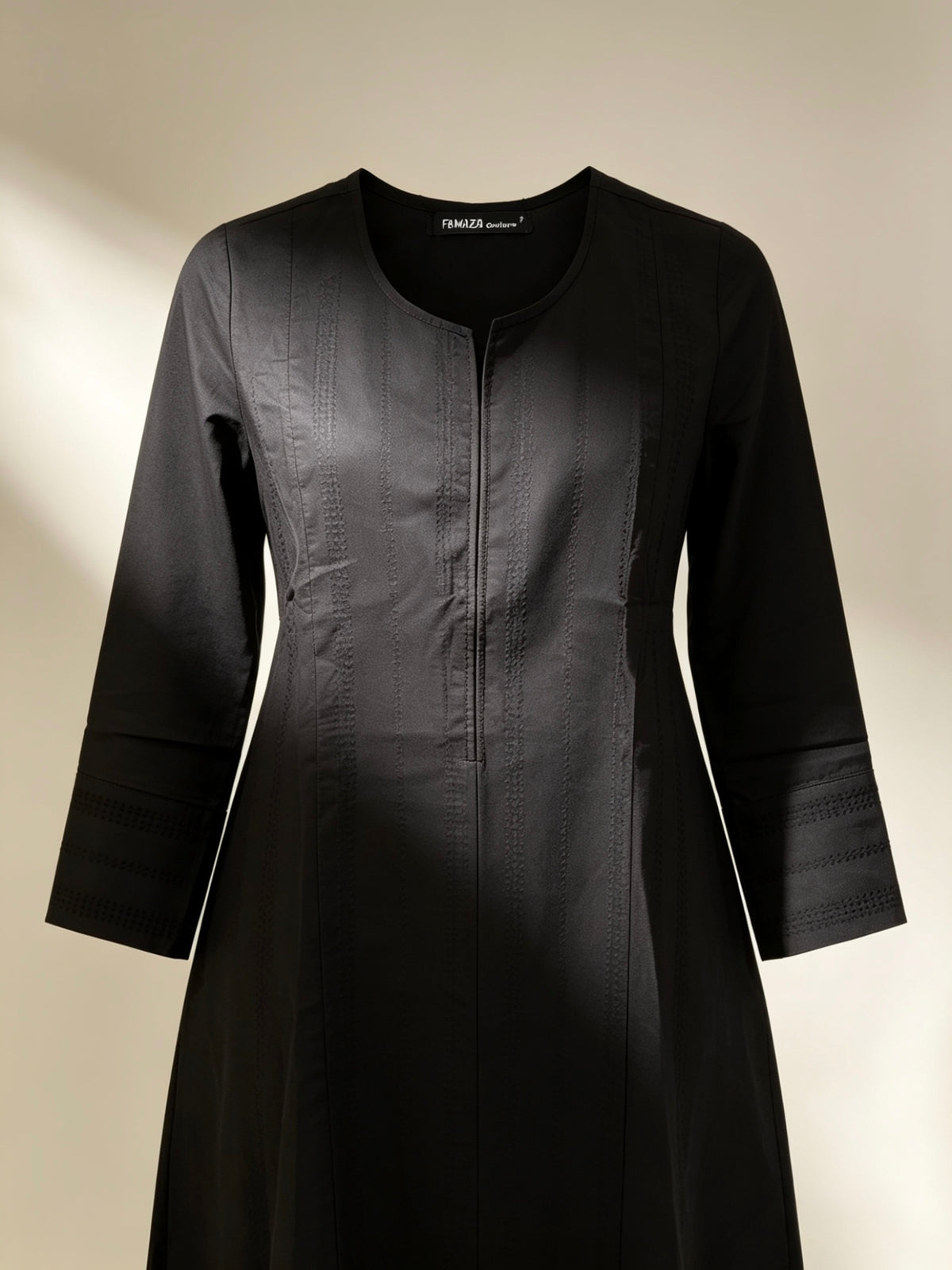 Black dress with long sleeves on a beige background