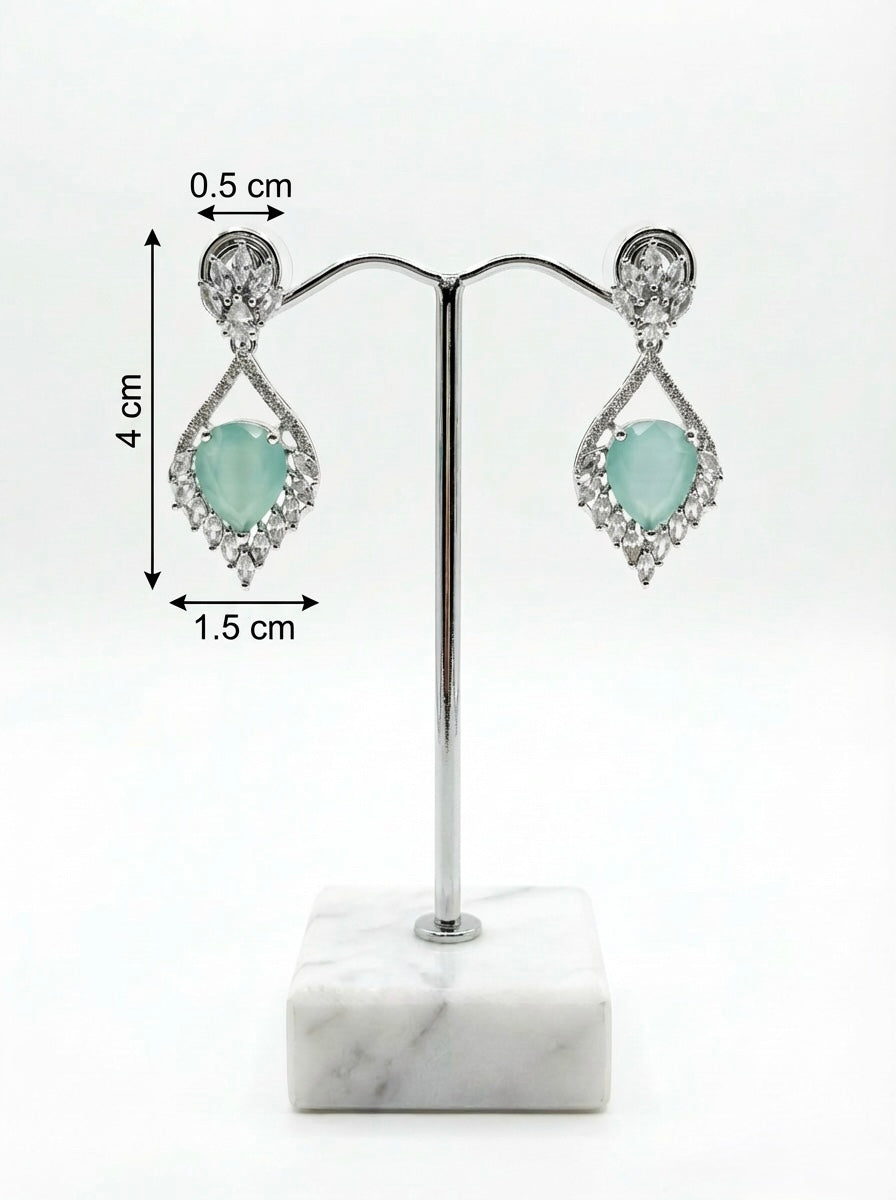 Earrings on a stand with measurements on a white background