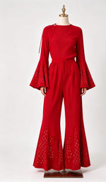 Red embroidered gharara with detailed motifs and mukaish accents, flowy wide-leg silhouette, lightweight fabric.
