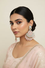 Elegant baby pink traditional earrings featuring intricate Kundan-style work and delicate pearl accents.