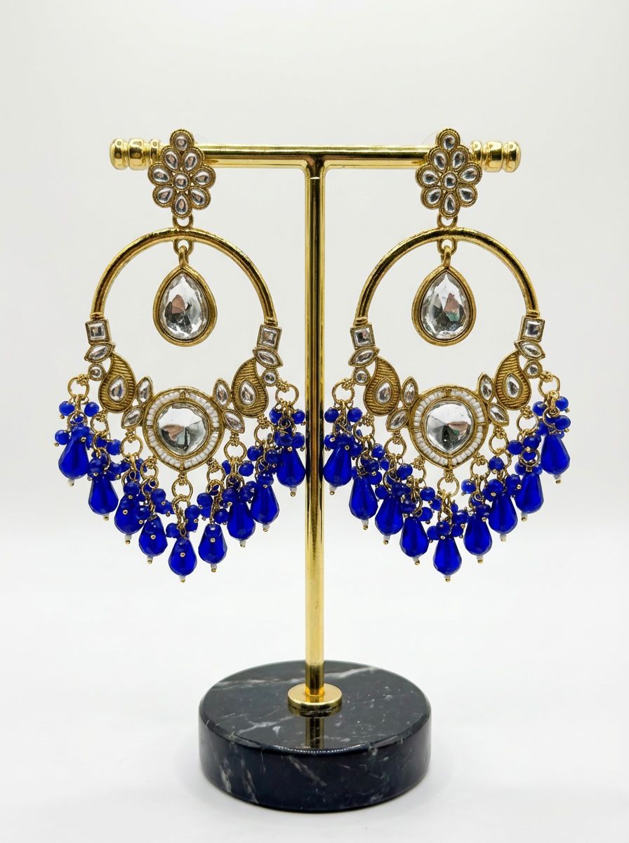 Elegant ethnic statement earrings in rose gold finish with sapphire blue accents, perfect for formal occasions.