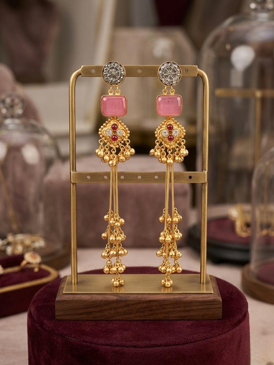 Elegant gold-toned laurel leaf earrings featuring a soft pink-colored cushion-cut stone drop.
